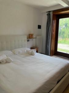 Letto o letti in una camera di Rifugio Baita Belvedere
