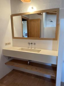 a bathroom with a sink and a mirror at Can Casellas in Palau Sator +22 photos