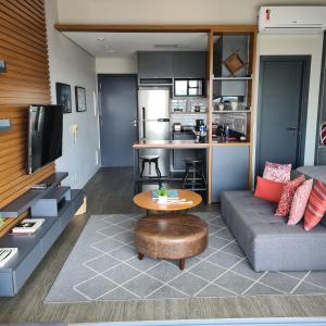 een woonkamer met een bank en een tafel bij Moderno Oca Moema in Sao Paulo