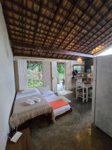 a bedroom with a bed and a desk in it at Stay Cool Pipa in Pipa