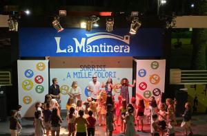 a group of people standing on a stage with a crowd at Villaggio Turistico La Mantinera - Residence in Praia a Mare