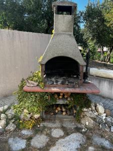 an outdoor oven is sitting next to a wall at Oaza mira in Podstrana