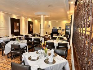 a restaurant with tables and chairs with white table cloth at Hotel del Fresno in Fresnillo de González Echeverría