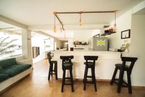 a kitchen and living room with a bar with stools at hotel turqueza inn in Armenia