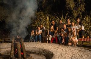 a group of people standing in front of a fire at hotel turqueza inn in Armenia