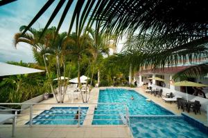 a pool at a resort with palm trees at hotel turqueza inn in Armenia