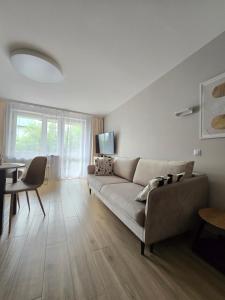 a living room with a couch and a table at Apartament Emili VIPOO in Suwałki