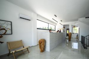 a lobby with a counter and people in a room at Elion Seaside Resort in Eretria +63 photos