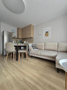 a living room with a couch and a table at Apartament Emili VIPOO in Suwałki