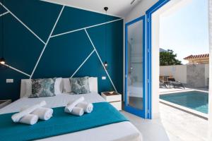 a bedroom with a blue wall and a bed with white pillows at Bed and Breakfast Da Francesca in Castelluzzo