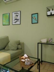 a living room with a couch and a glass table at Orsiida Seaside Cottage KGatzea in Kato Gatzea
