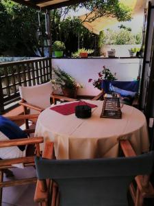 a table and chairs on a patio with a tableablish at Orsiida Seaside Cottage KGatzea in Kato Gatzea