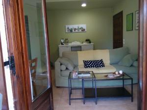 a living room with a couch and a table at Orsiida Seaside Cottage KGatzea in Kato Gatzea