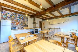 a restaurant with wooden tables and chairs and a kitchen at Naéco Erdeven in Erdeven