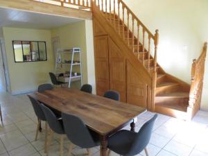 a dining room with a wooden table and chairs at Au Bonheur Suspendu in Pont-en-Royans +13 photos