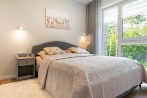 Postel nebo postele na pokoji v ubytování “Vanagupės pušyno SPA” apartamentai