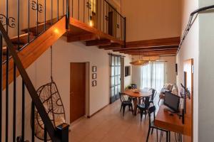 a living room with a staircase and a table with chairs at Habitación en Hospedaje Achalay, Qué lindo ! Qué bueno ! in Santa Fe