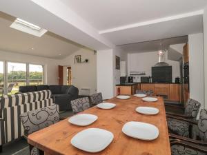 a living room with a wooden table and chairs at Primrose Cottage in Watchet