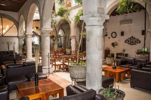 a lobby with couches and tables and chairs at Hostal de La Monja in Durango