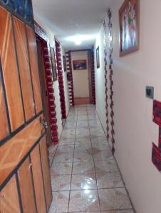 a hallway with a door and a tile floor at Crocro house in Baños