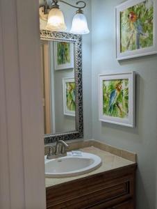 a bathroom with a sink and a mirror at Gulf Side Villa 1B in Pensacola +17 photos