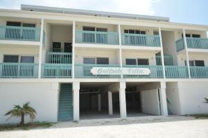 a large white building with blue balconies on it at Gulf Side Villa 1B in Pensacola