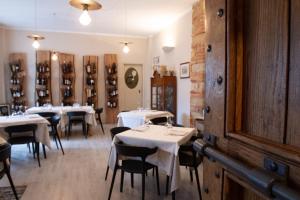 a restaurant with white tables and chairs in a room at dormire e mangiare da Geppe in Montemagno