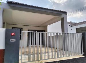 a house with a gate in front of it at Rumah SK in Batu Kurau