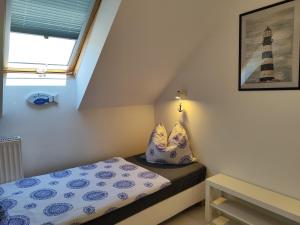 a bedroom with a bed and a window with a lighthouse at No 12 in Pobierowo