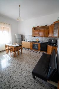 a kitchen with a couch and a table in a room at Cappuccini apartments superior in Oristano
