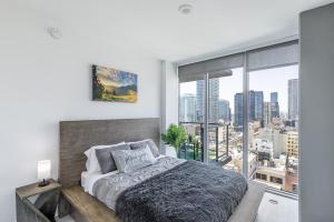 a bedroom with a bed and a large window at Top Floor High Rise 3 Bed DTLA Skyscraper Penthouse in Los Angeles