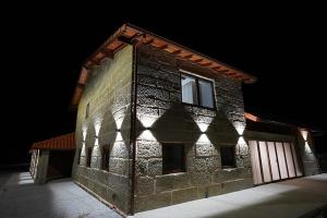a brick building with the light shining on it at Refugio do Tempo in Beça