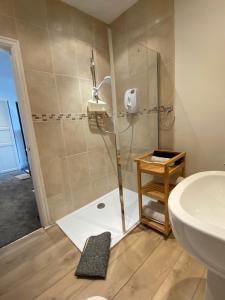 a bathroom with a shower with a sink and a toilet at ParkRoyal Blackpool in Blackpool +51 photos