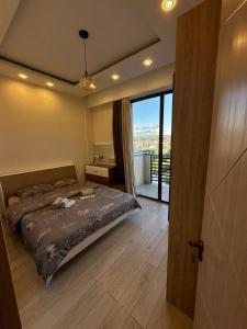 a bedroom with a bed and a large window at Apartment in the center Tbilisi in Tbilisi City +5 photos