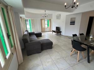 a living room with a couch and a table at city center accommodation in Nicosia