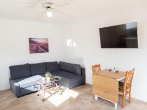 a living room with a couch and a table at Villa Estrella Polar in Tahiche