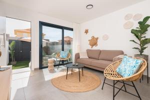 a living room with a couch and a table at Vivienda Las Arecas - El Médano in El Médano