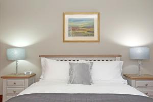 A bed or beds in a room at Aberdeen Lighthouse Cottages - coastal, dolphins