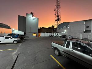 a parking lot with cars parked in front of a building at Hotel Varginha III in Varginha