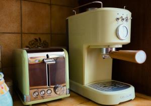 a coffee maker sitting on a counter next to a toaster at Location de Chambres Bienvenue chez Mémé in Treigny