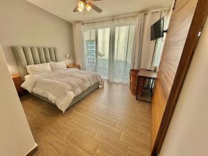 a bedroom with a bed and a flat screen tv at Quinta Los Caballos in Ajijic +10 photos