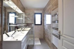 a bathroom with two sinks and two mirrors at La Villa Caennaise II in Grentheville +11 photos