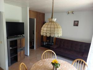 a living room with a table and a couch at Bungalov in Gozd Martuljek