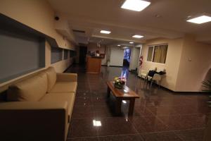 a living room with a couch and a coffee table at Hotel El Cortijo in Neuquén