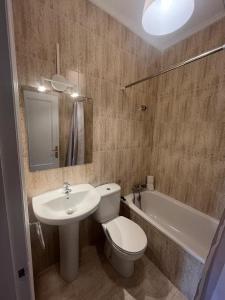 a bathroom with a toilet and a sink and a tub at Mies de Prado in Comillas