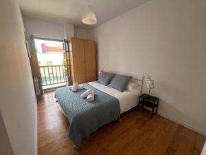 a bedroom with a bed with two towels on it at Mies de Prado in Comillas +8 photos