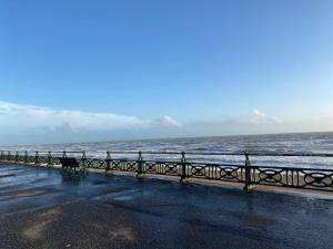 a bench on the beach near the ocean at Blue Beach in Hove