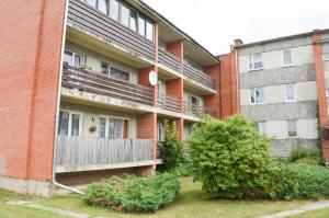 an apartment building with a porch and a fence at Cherry Apartment in Madliena