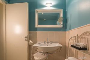 a bathroom with a sink and a mirror at Hotel San Pietro Palace in Finale Ligure
