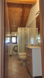 a bathroom with a toilet and a sink at Appartamento vacanza Coredo Trentino in Coredo